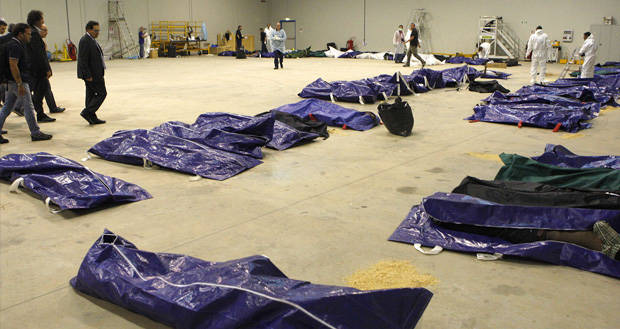 I cadaveri nell'hangar dell'aeroporto di Lampedusa. (Foto corriere.it)